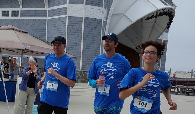 Runners run past the Sea Shell Stage in Hampton Beach