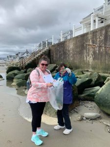 Two volunteers at a beach cleanup