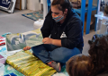 Niki reading to a Blue Ocean Discovery Center visitor