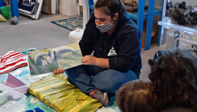 Niki reading to a Blue Ocean Discovery Center visitor